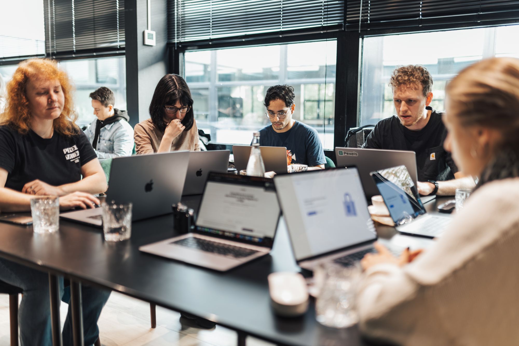People working on laptops together at a hands-on workshop